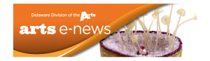 Delaware Division of the Arts e-news logo on orange background in upper left corner slightly covering a yellow and purple sculpture with off white tendrils coming out its top that is on the right side of the banner
