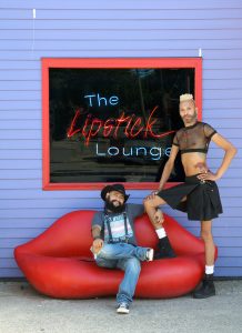 A photo of two people on a couch shaped like human lips. “Z and Jabari, Nashville,” 2021 by B. Proud