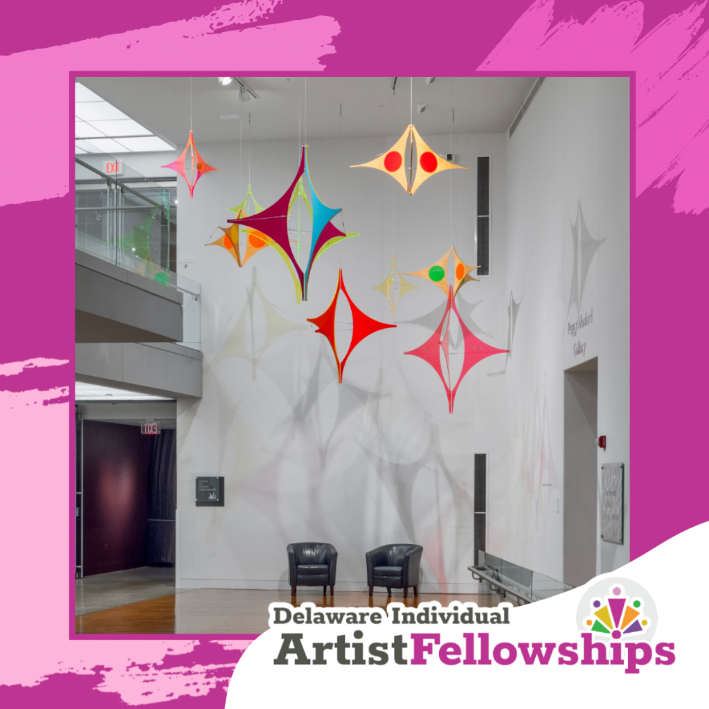 Square promotional graphic for Delaware Individual Artist Fellowships featuring a gallery installation photo framed by pink brush-stroke accents and the program logo.