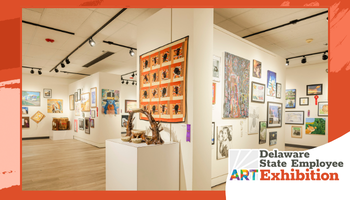 Wide promotional banner showing a bright gallery interior filled with framed artwork on white walls, with a central white pedestal displaying a sculpture. Track lighting runs along the ceiling, and an orange graphic border frames the image. In the lower right, a badge reads “Delaware State Employee ART Exhibition,” with “ART” in multicolored letters.