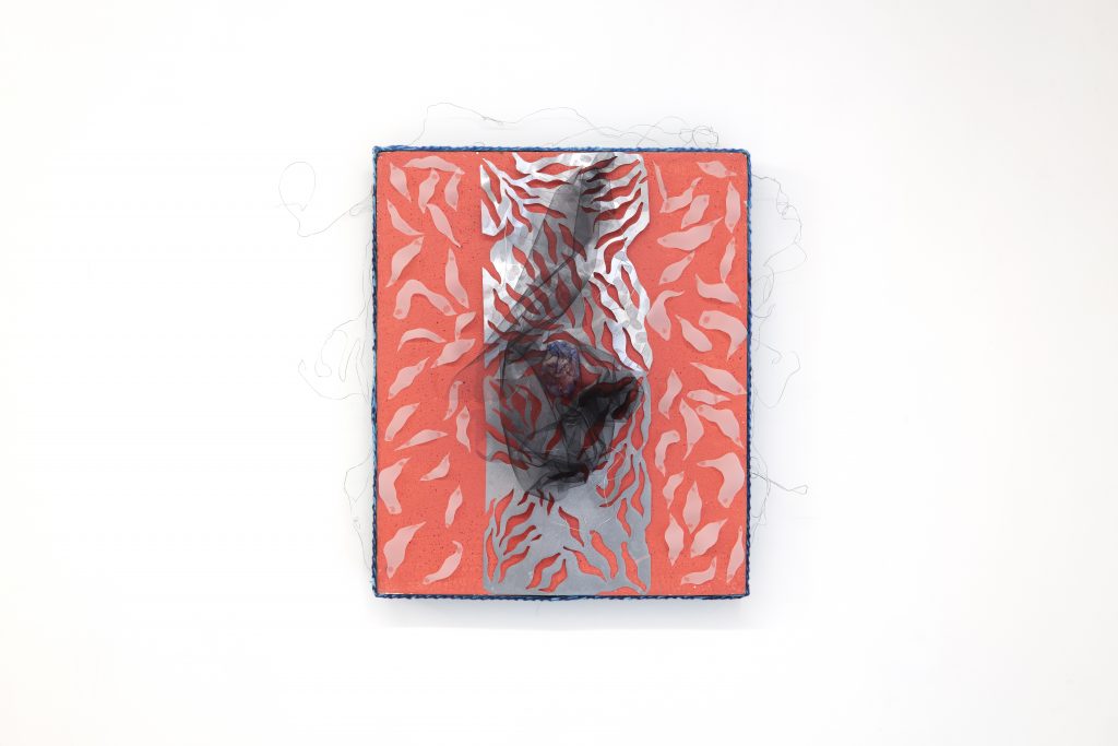 Square mixed-media wall work in fluorescent coral pink and pale gray, featuring repeating organic cutout shapes and a dark translucent central form layered over the surface. Loose strands of thread extend beyond the edges, giving the piece a delicate, handmade quality against the white wall.