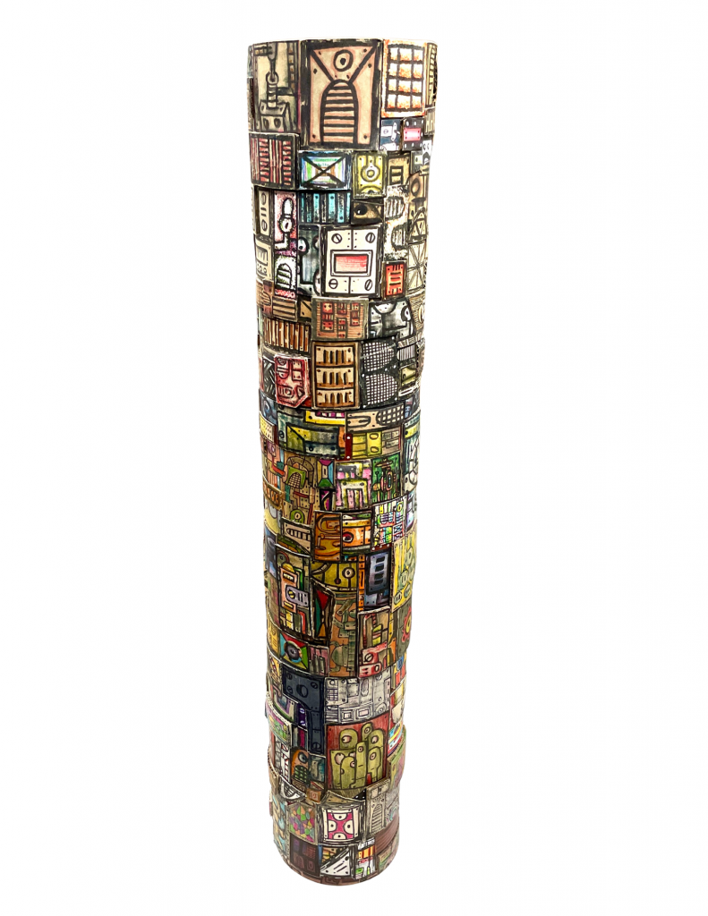 Tall cylindrical sculpture covered from top to bottom with tightly packed hand-drawn rectangular panels resembling doors, windows, control boxes, and abstract architectural details. The surface is filled with muted cream, brown, yellow, green, red, and gray tones, giving the column a totemic, city-like appearance.