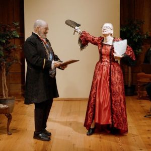 Two people singing in period garb