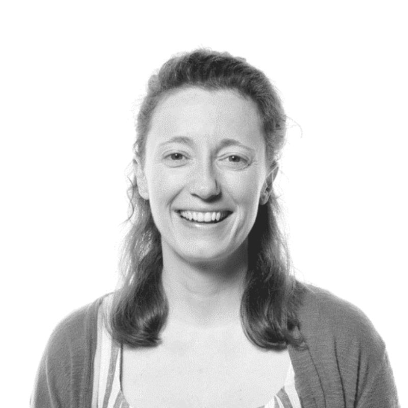 a smiling white woman with long brown hair smiling directly at the camera with a white background
